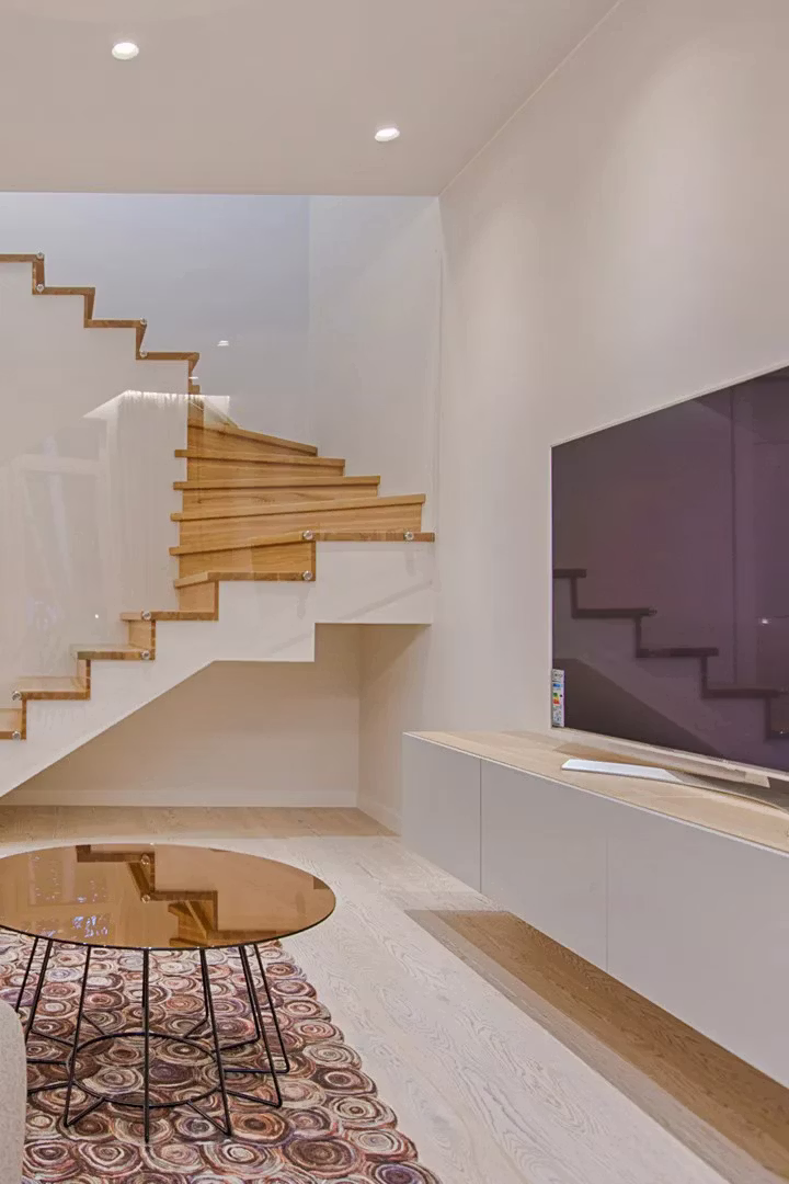 Finished basement living space with a staircase and light flooring in Moorestown, NJ